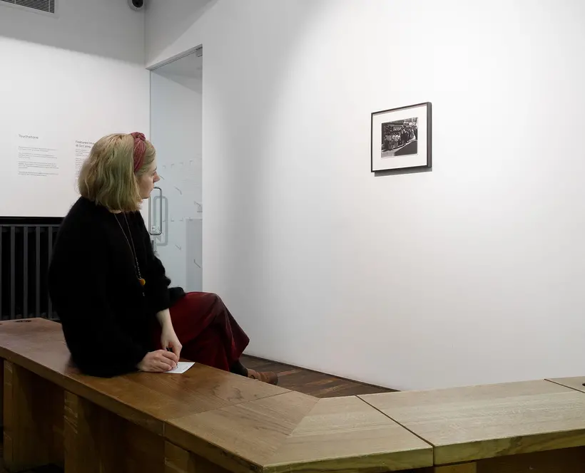 A visitor engages with an image by looking at it slowly over a period of time.