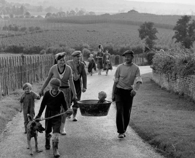 Black and white image of people walking.
