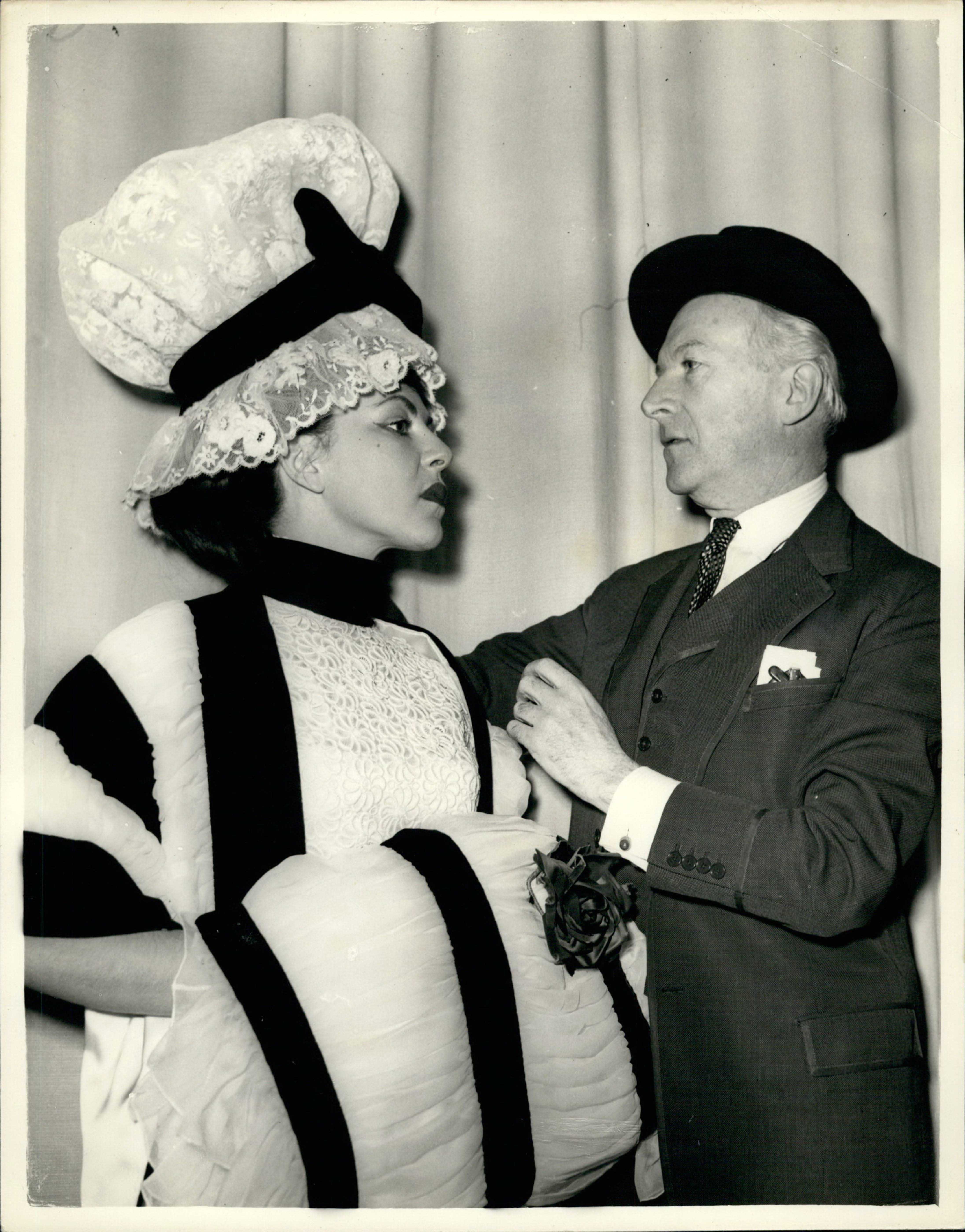 Photo: Cecil Beaton pictured supervising the fitting of his costumes for 'My Fair Lady', 1958, Keystone Pictures USA / Alamy Stock Photo