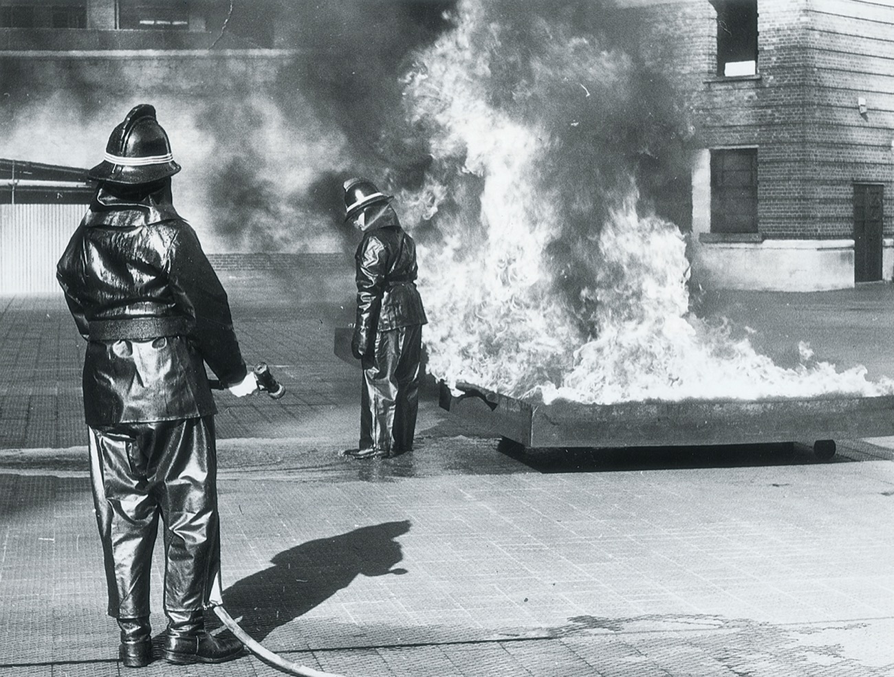 Demonstration of Tele Noflam Protective Suit at Brigade Headquarters: September 1965 Suit being subjected to heat with no protecting water spray, the wearer experienced little or no discomfort.