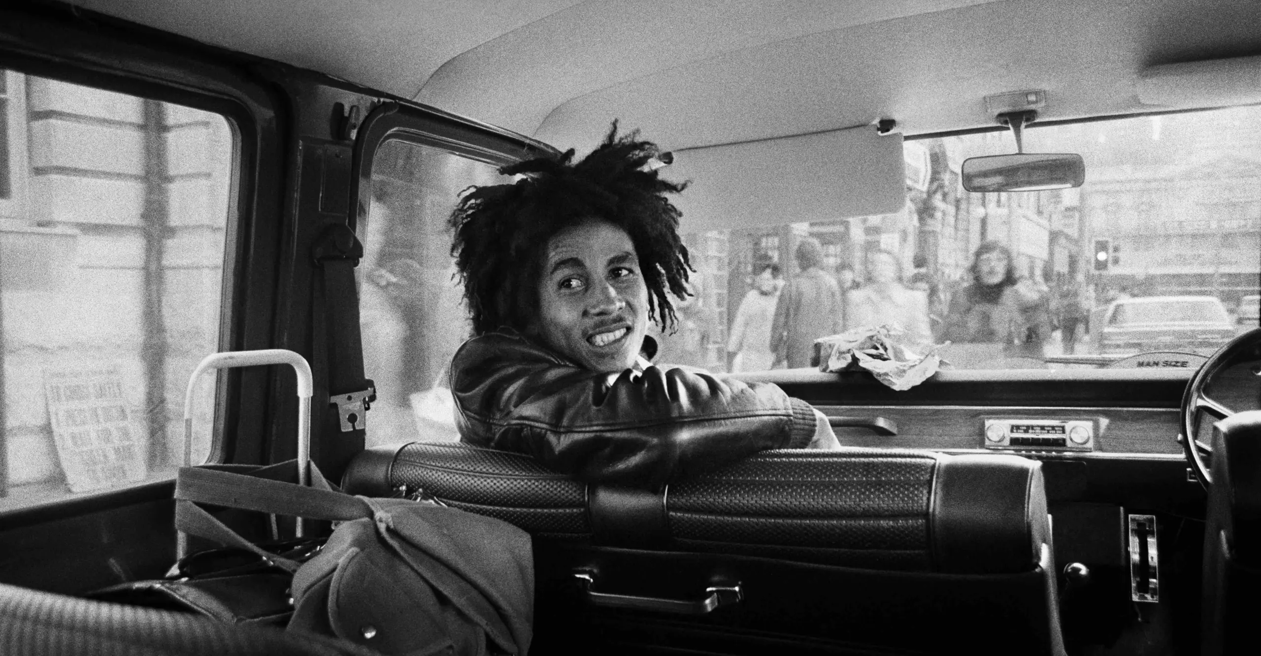 Black and White image of Bob Marley on a tour bus.