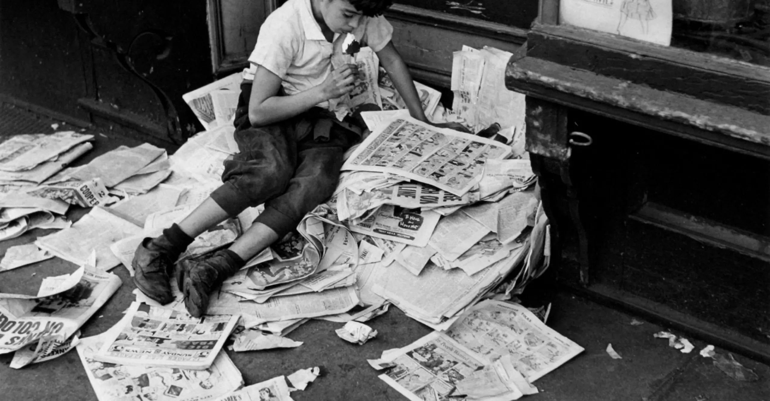 André Kertész, Boy reading newspaper , 1944 © The Estate of André Kertész / Courtesy of Stephen Bulger Gallery