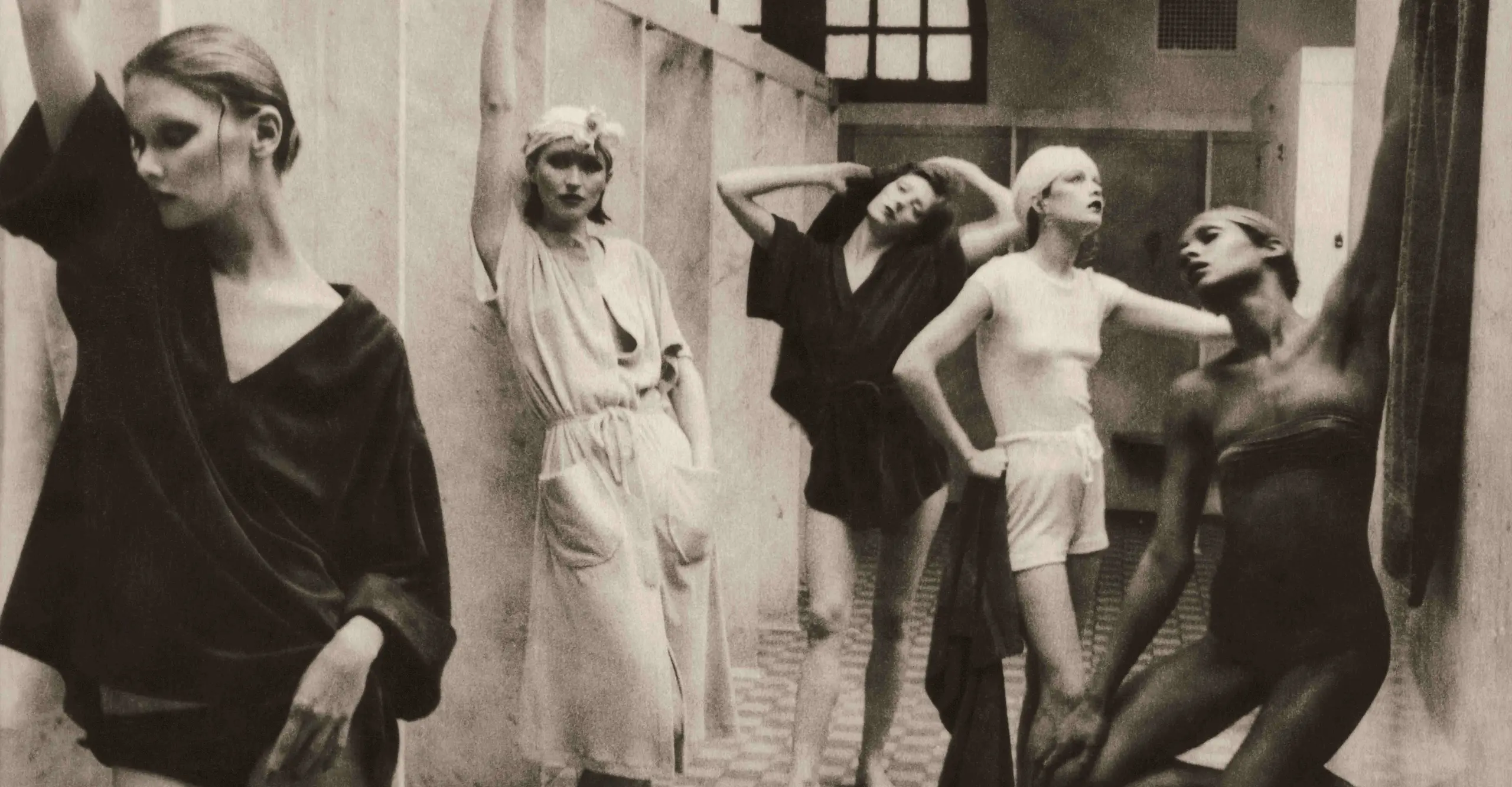 Photograph of five women standing and posing in a bathhouse