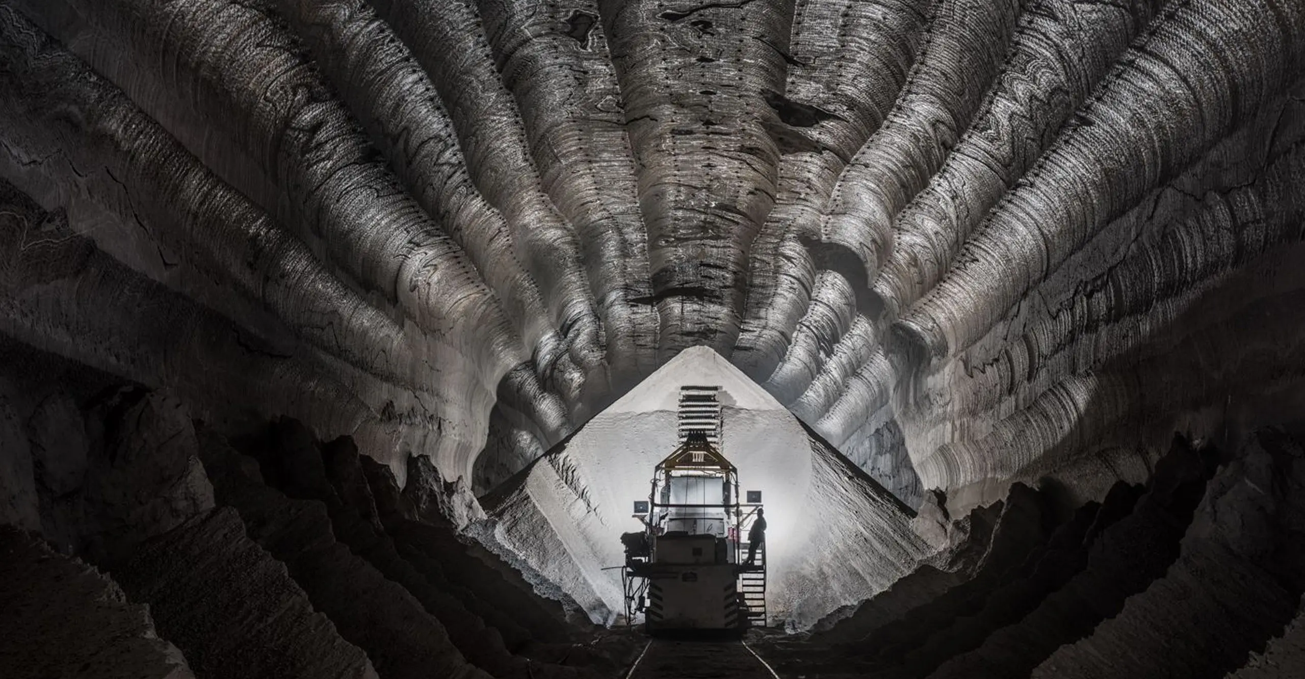 Image of dark cavernous sea-shell like interior of a working mine in Russia. 