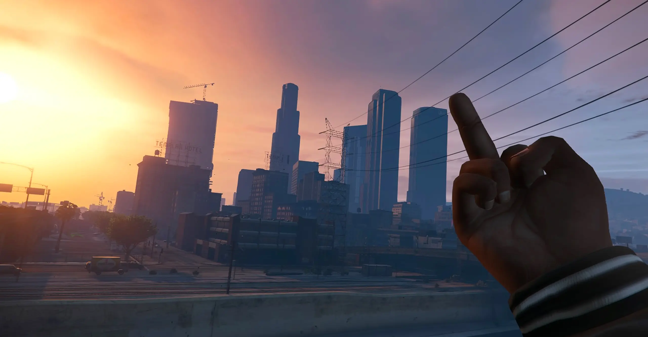 A still from a video game showing a hand giving the middle finger to the skyline of a city on sunset