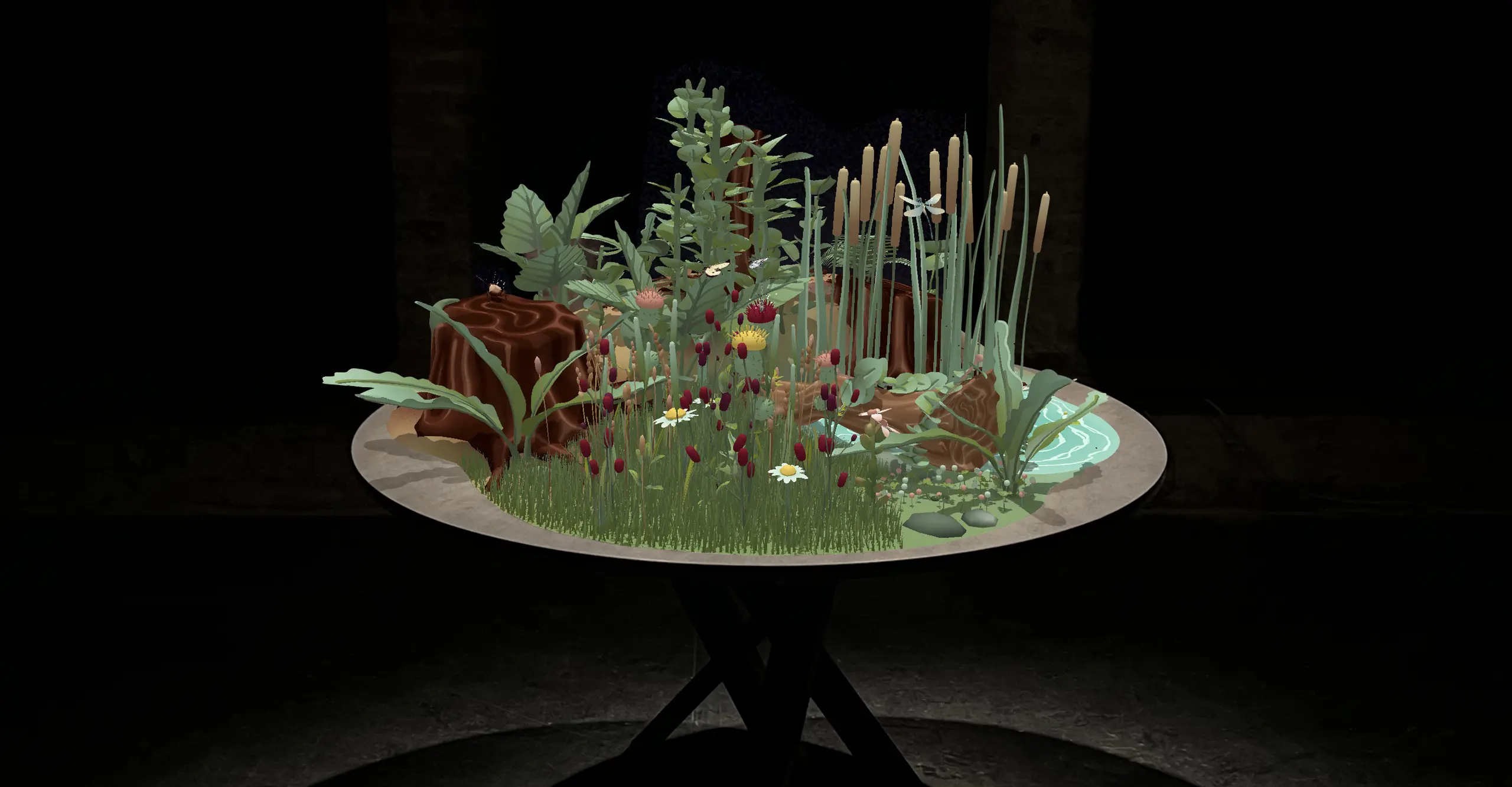 A cgi landscape of a natural ecosystem including daisies, leaves, logs, and water appears on a round table in a dark space