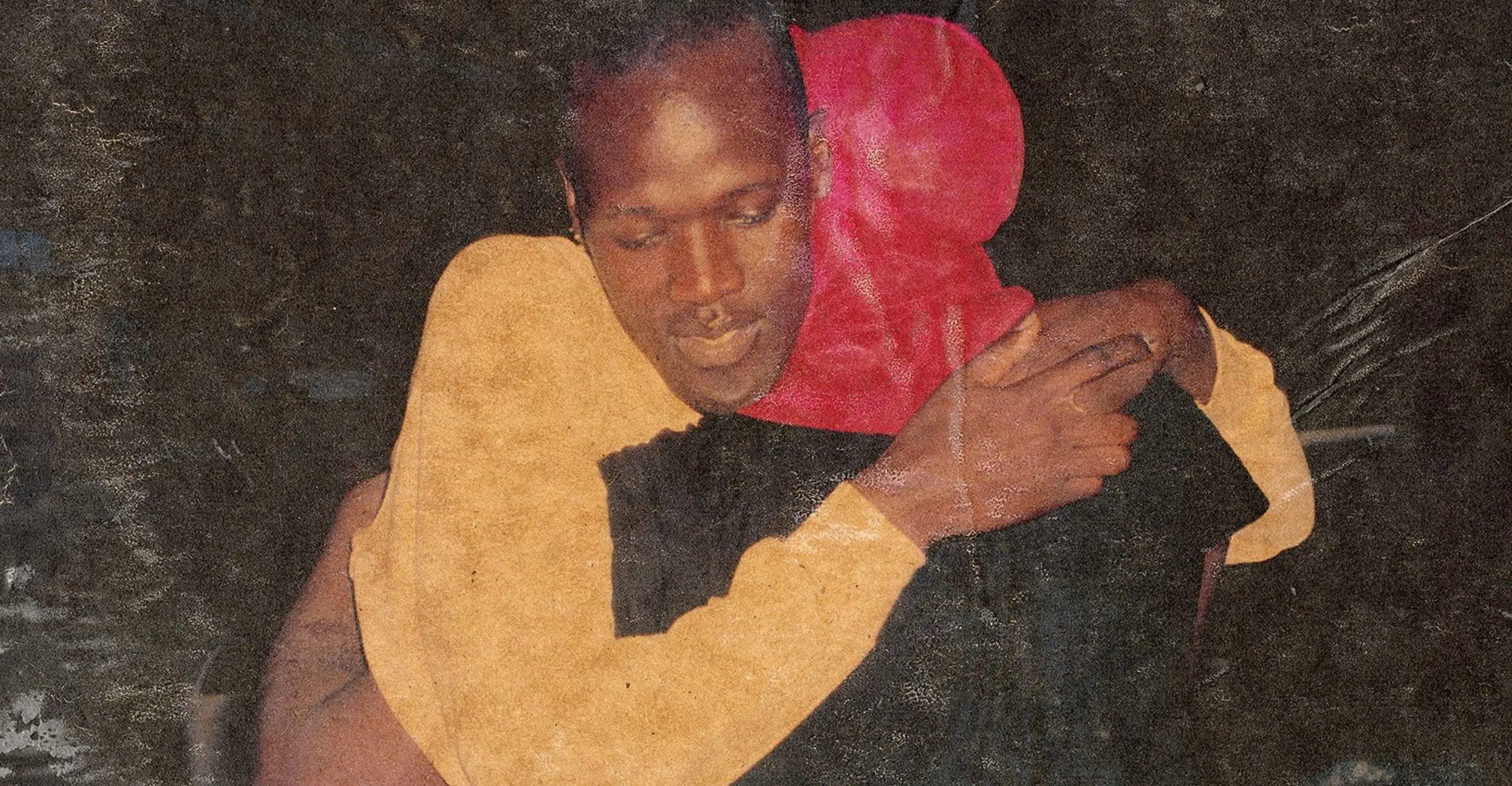 colour photo of two people in embrace.