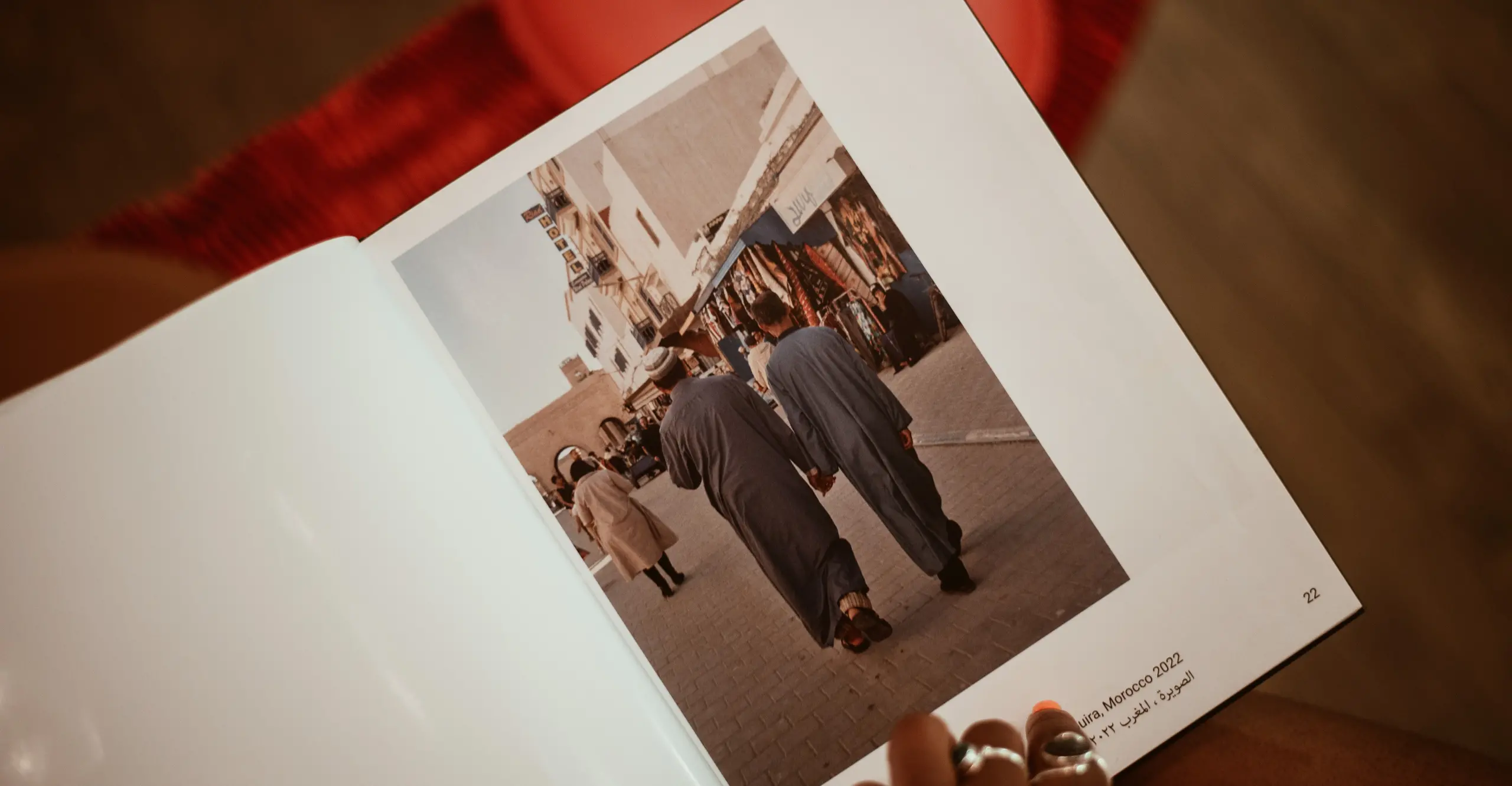 An open book with a hand holding it 