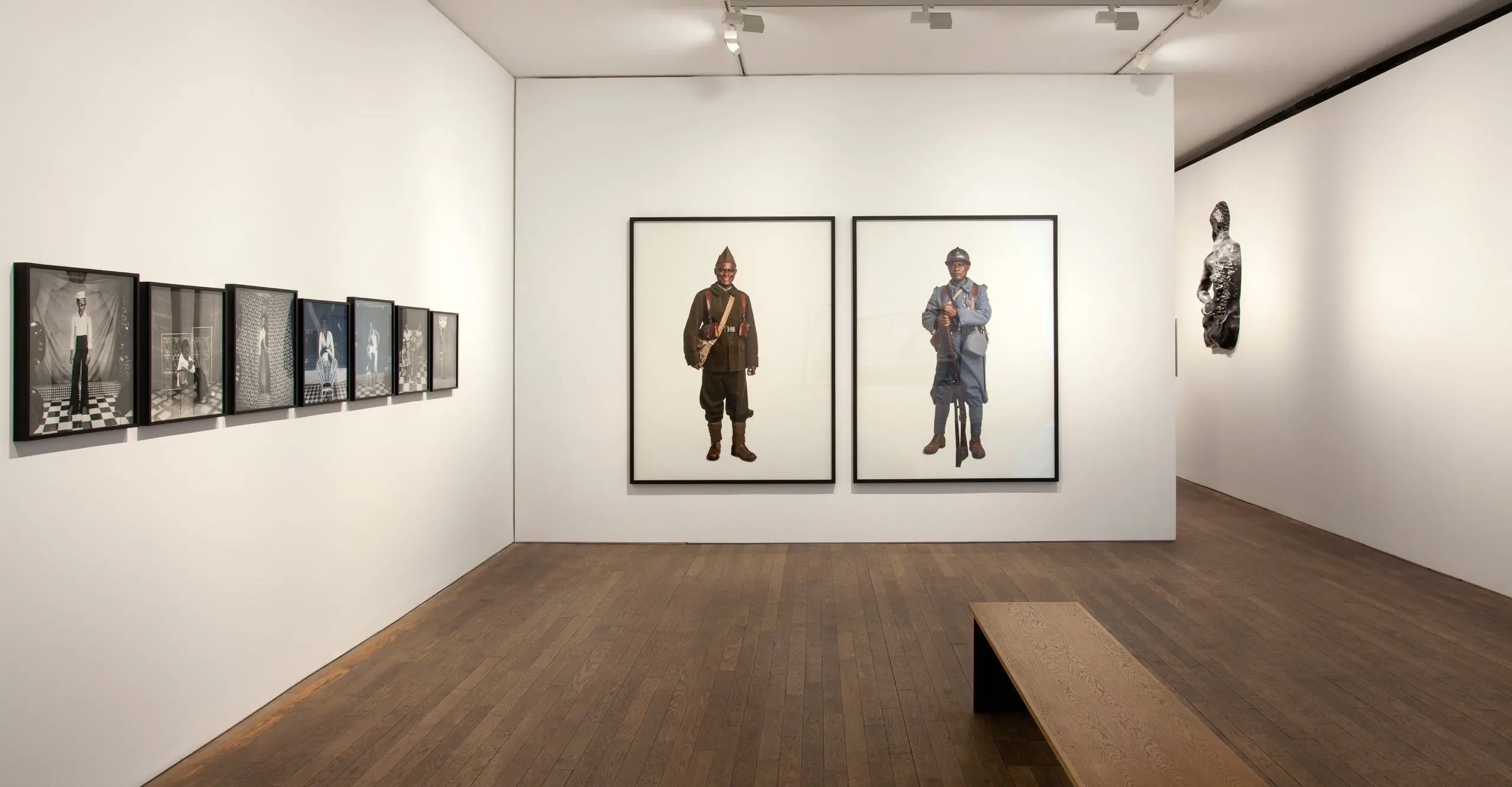 Colour photograph of Gallery interior with large framed portrait photographs on the wall
