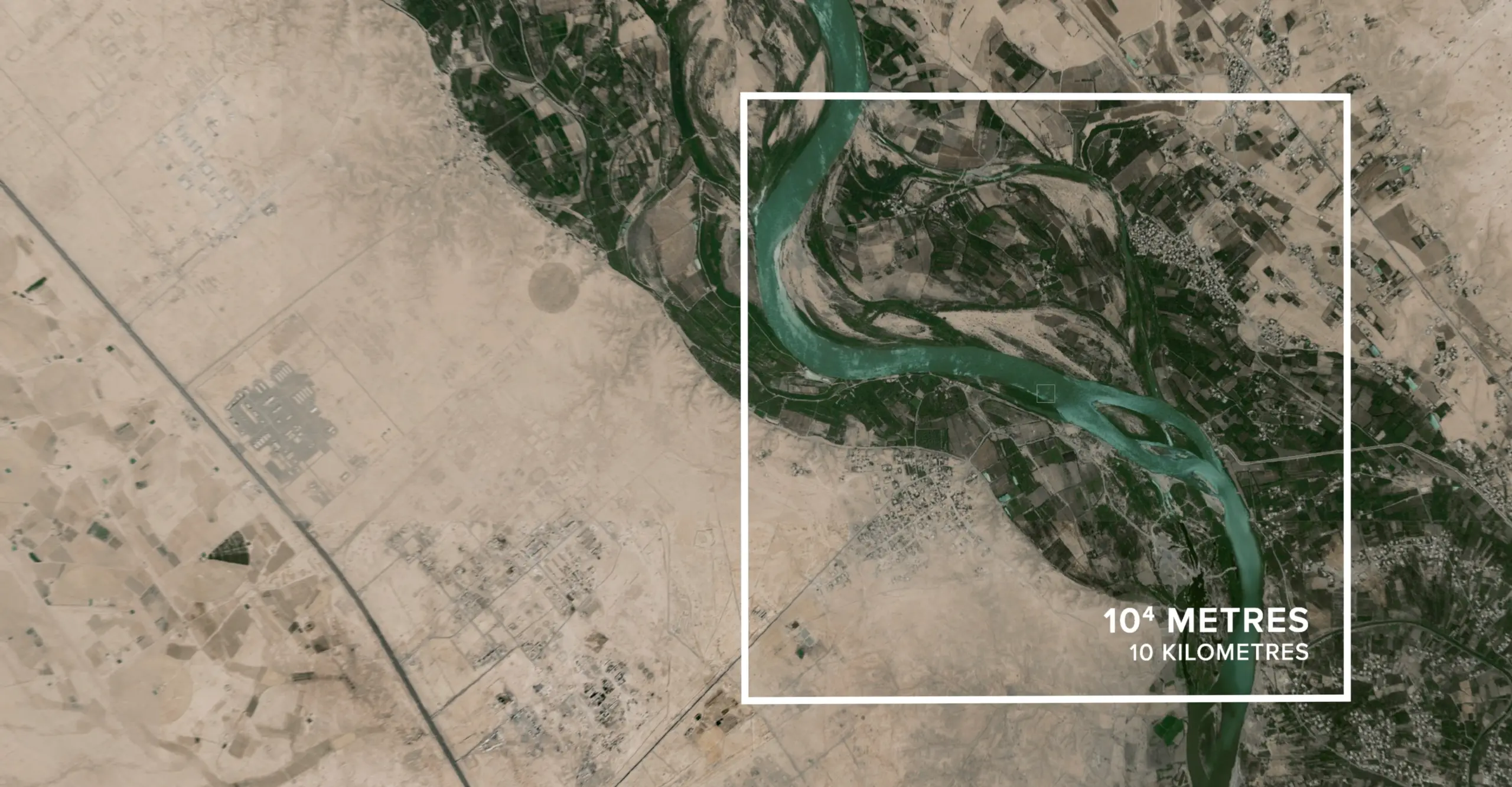 An aerial photograph of a greenish river running through an arid environment, with a superimposed white square on the centre, with text inside reading: 10^4 metres, 10 Kilometres