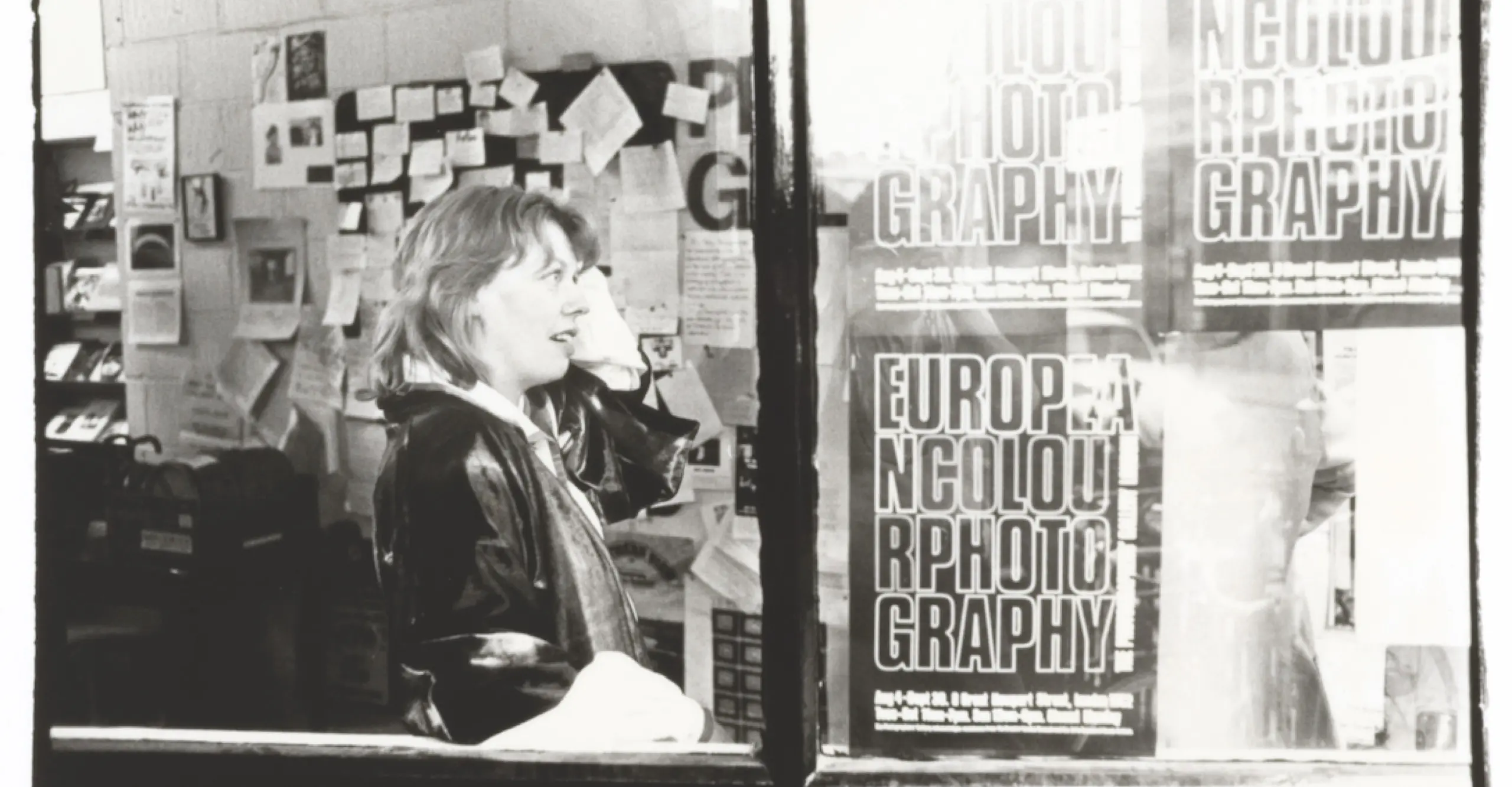Sue Davies, founding director of The Photographers' Gallery, pictured with New European Colour photography posters, 1978. Photographer unknown