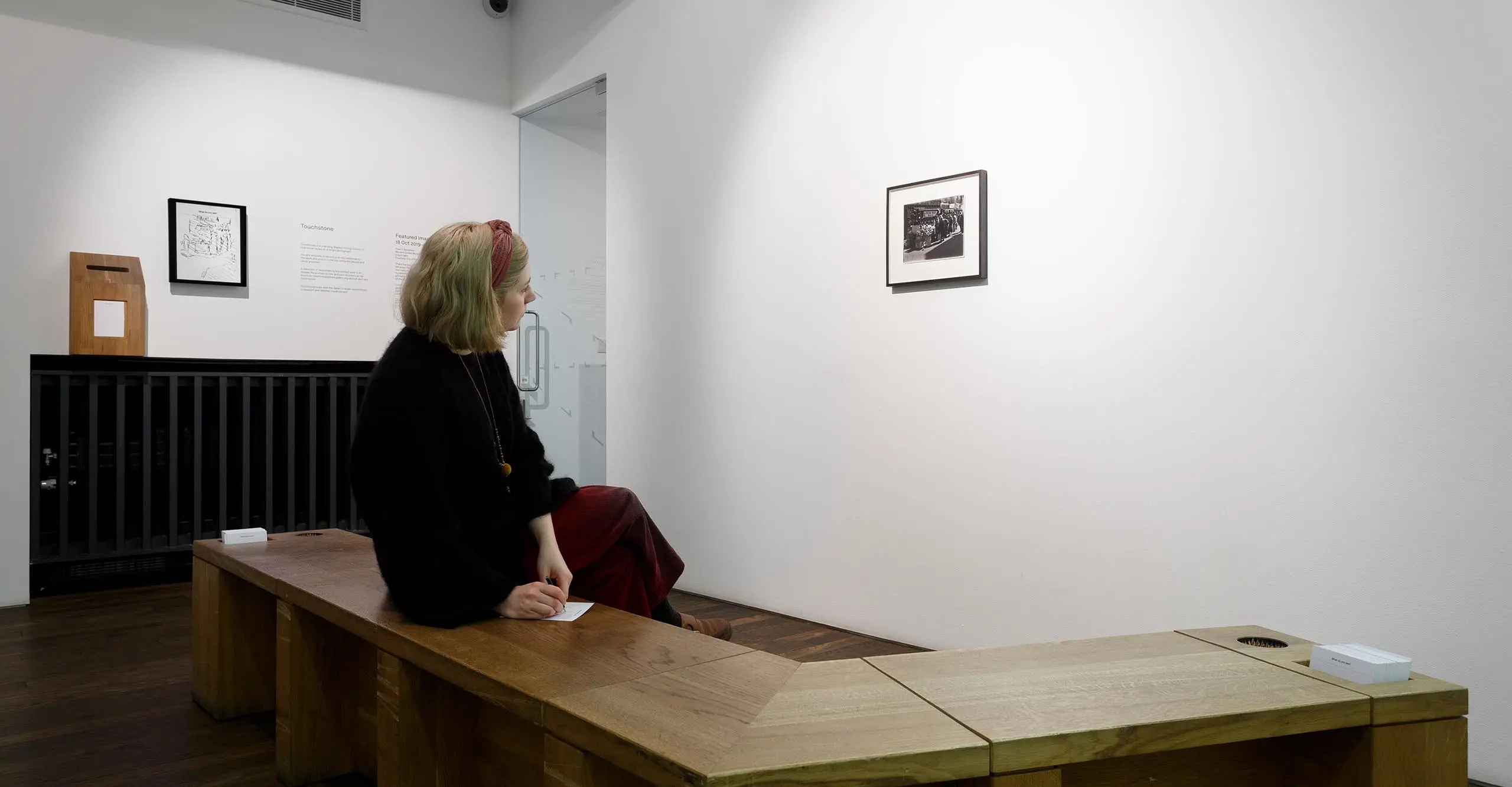 A visitor engages with an image by looking at it slowly over a period of time.