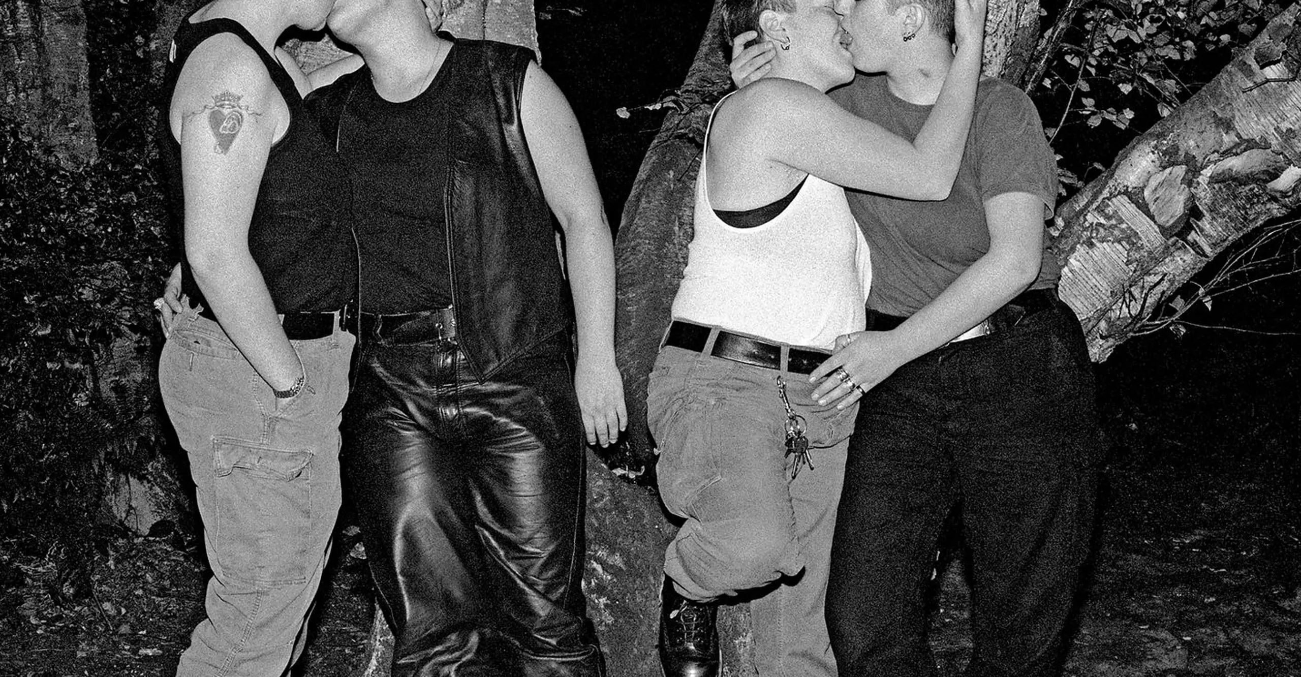 Bw photograph of people kissing in a park at night