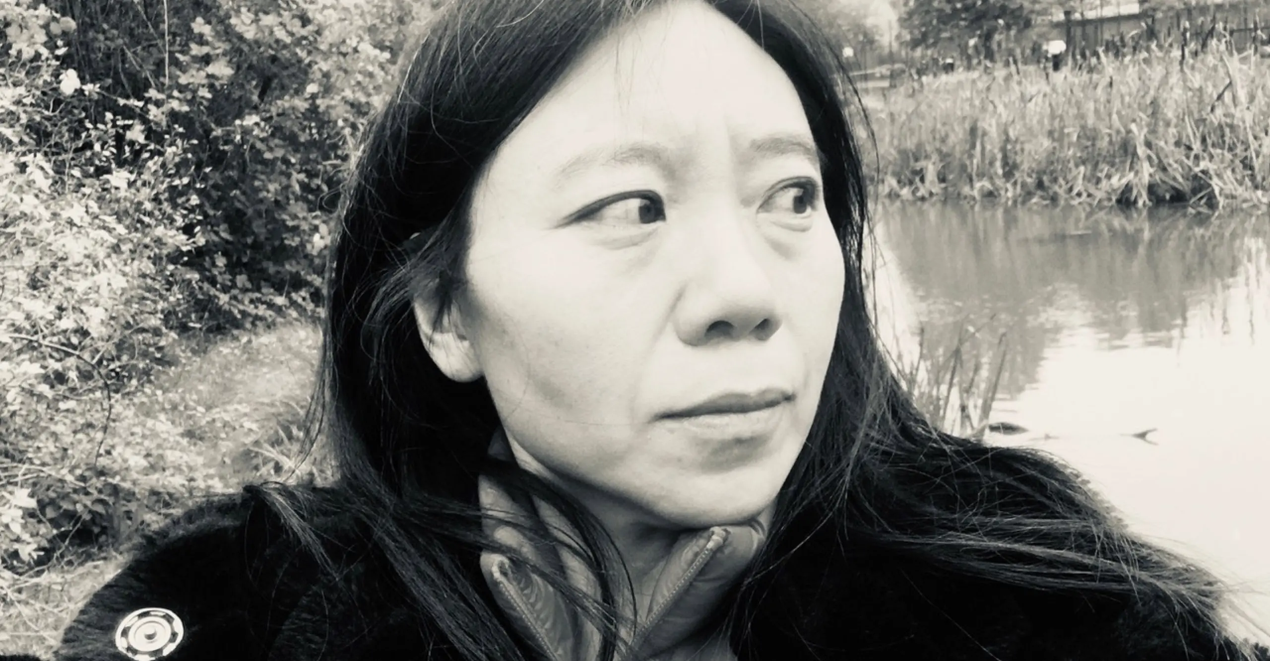 Landscape format B&W portrait of author and artist Xiaolu Guo