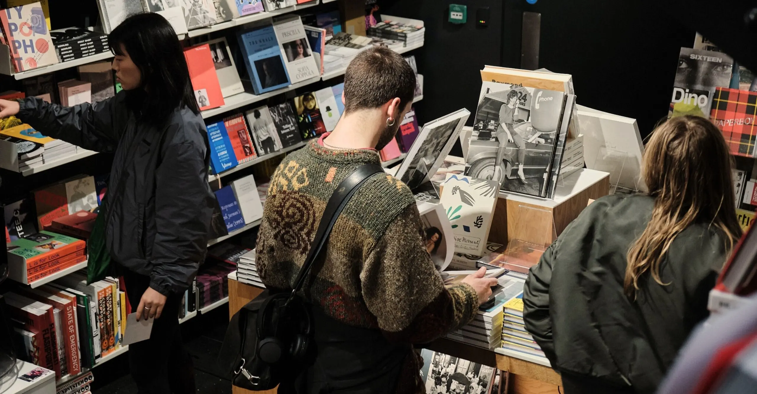 Colour photograph of people browsing books in the shop