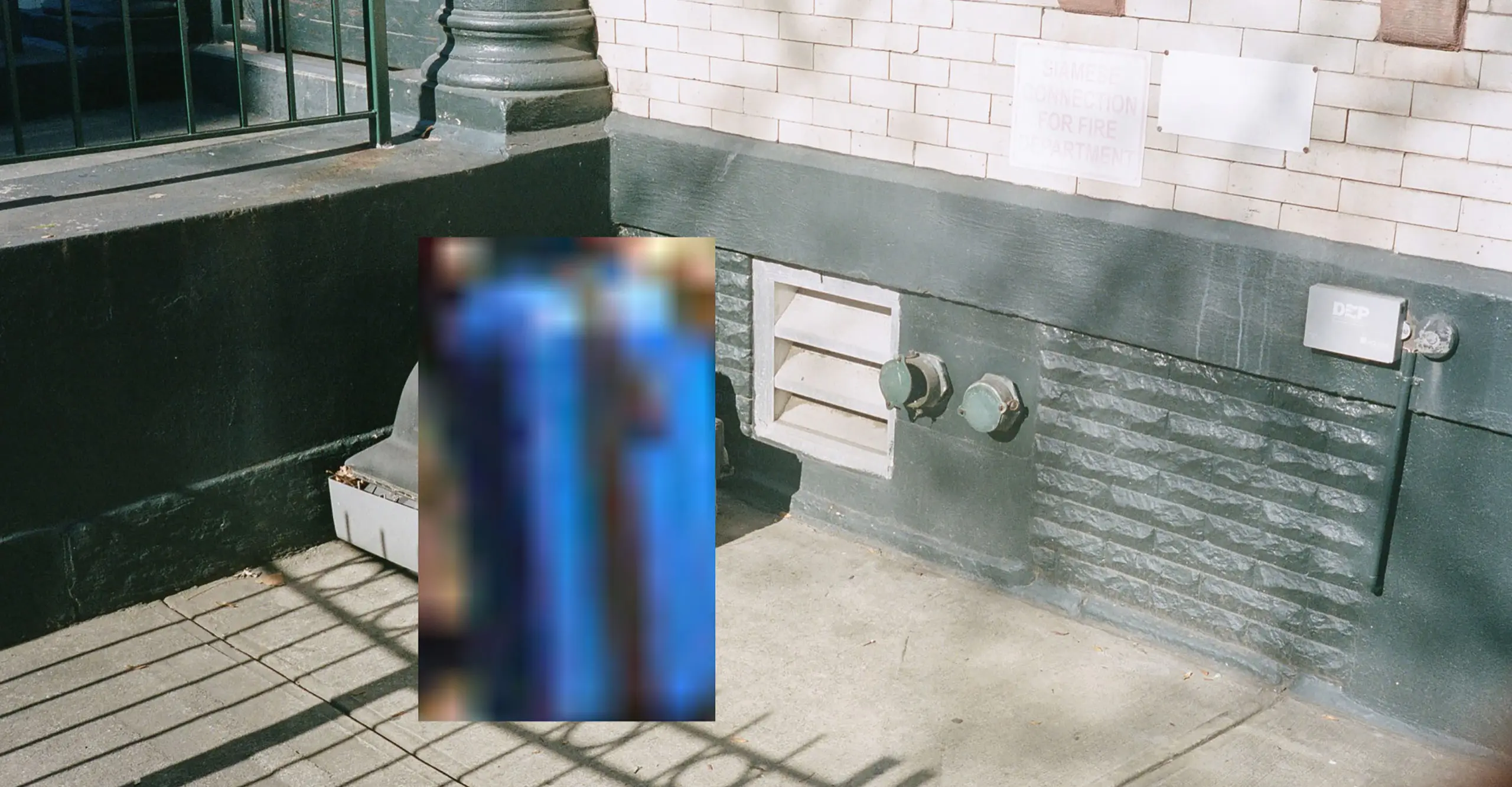a colour photograph of a street in New York. a glitched image of a suitcase is overlaid on top of an object. it is a screenshot of an artwork by Philipp Schmitt.