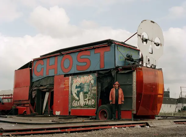 A colour image of a fairground ghost train amusement ride that looks run down.