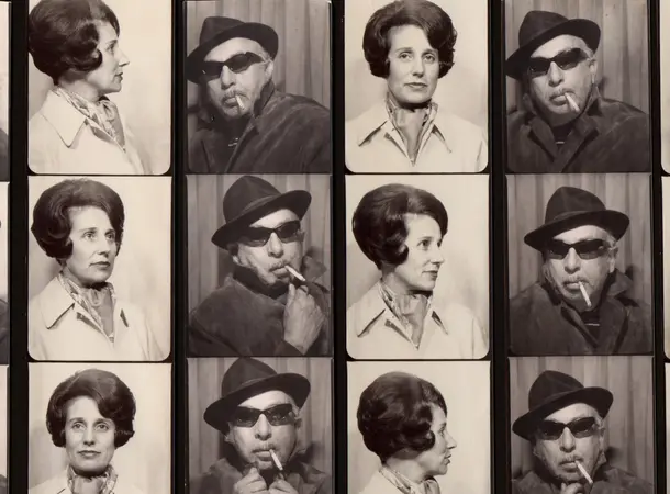 Black and White image of six sets of photobooth film strips showing a set of portraits of a man wearing a wide brimmed had and sunglasses and a woman with her hair pinned up, wearing a light coat.