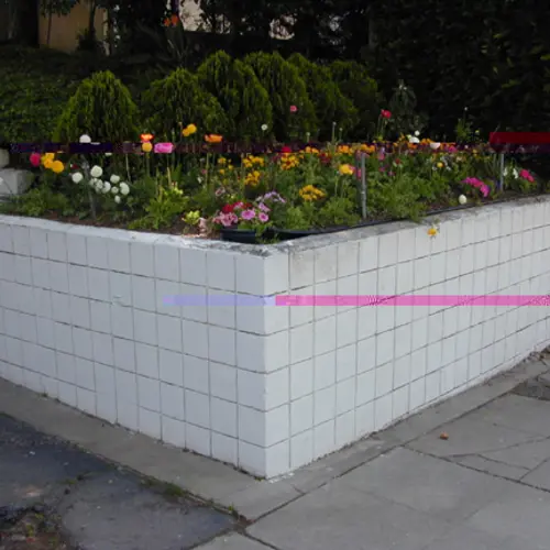 A glitchy photograph of an urban flowerbed with yellow flowers