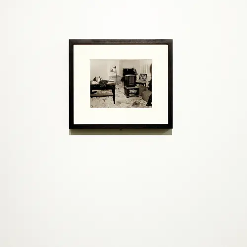Framed black and white photograph on a wall.