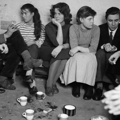 Black and White Photograph, by Roger Mayne, showig three women sitting down, drinking coffee and smoking at the Partisan Coffee House, displayed at The Photographers' Gallery in London