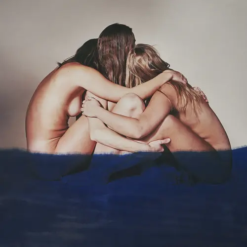 An image of three nude women leaning in embrace with one another with their backs to us. They are partially obscured by a swathe of dark blue paint.