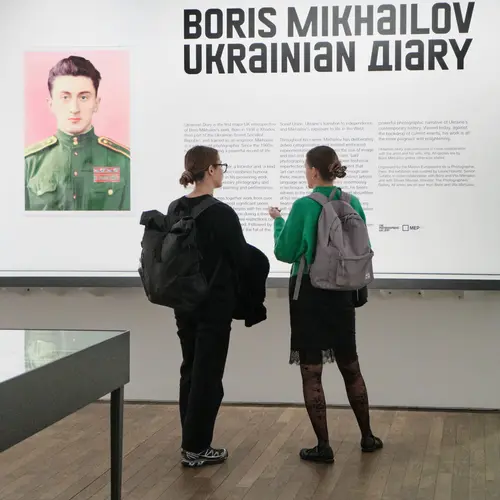 Two women reading a wall text in the Boris Mikhailov exhibition.