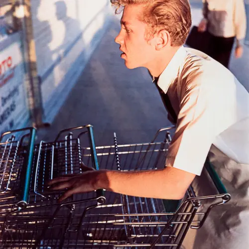 A young man collection shopping trollies