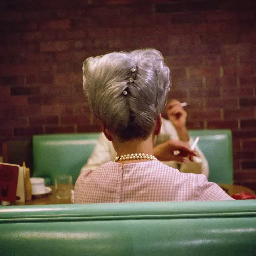 The back of a woman's head with a neat updo.