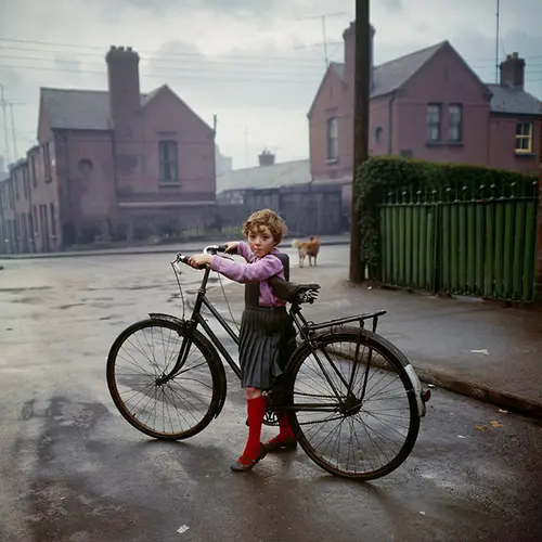 young girl stood with bike