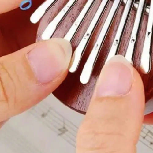 A close up photograph of two fingers holding a jewel 