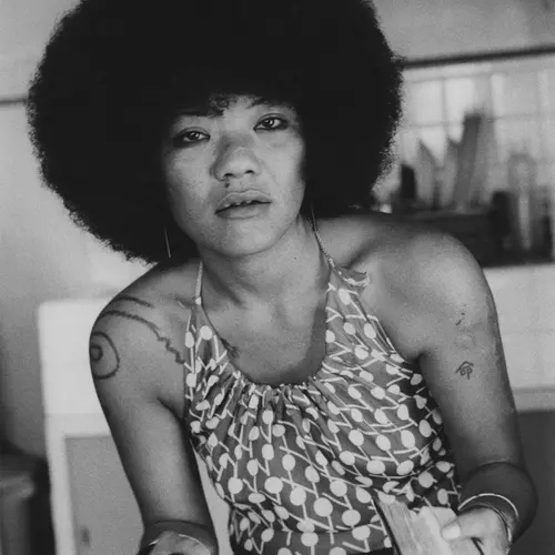Black and white photograph of a woman with afro hair posing for the camera