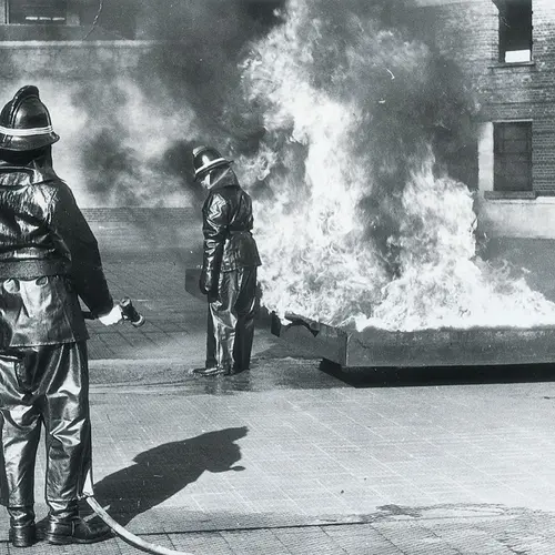 Demonstration of Tele Noflam Protective Suit at Brigade Headquarters: September 1965 Suit being subjected to heat with no protecting water spray, the wearer experienced little or no discomfort.