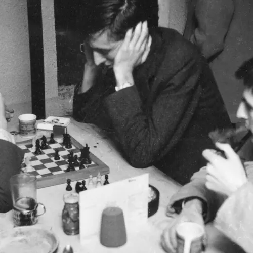 image of men at a table playing chess and discussing at the original partisan coffee house in soho, seen at the photographers gallery