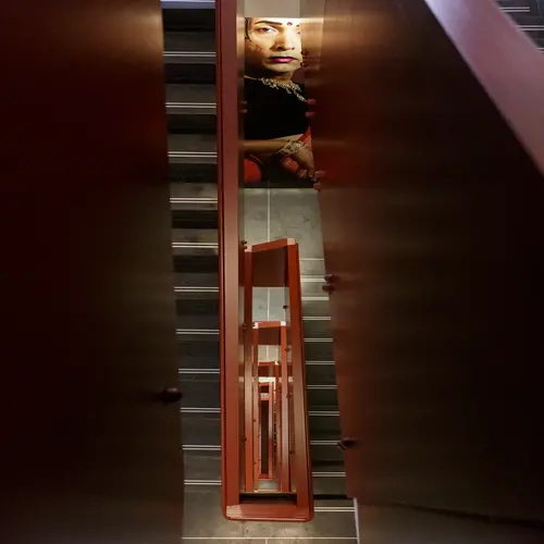 Looking down through the centre of a red staircase