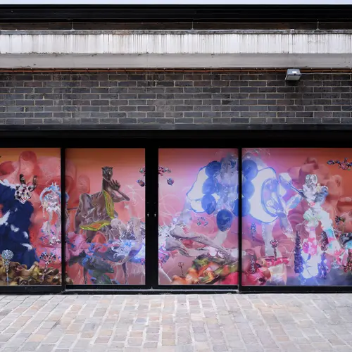 A vibrant collection of computer generated models covers street level windows