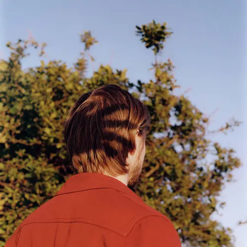 A persons back wearing a red shirt.
