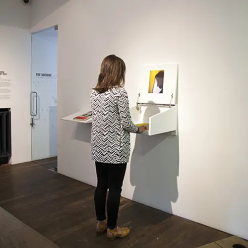 Visitor feeling and viewing a tactile print inside an open box.