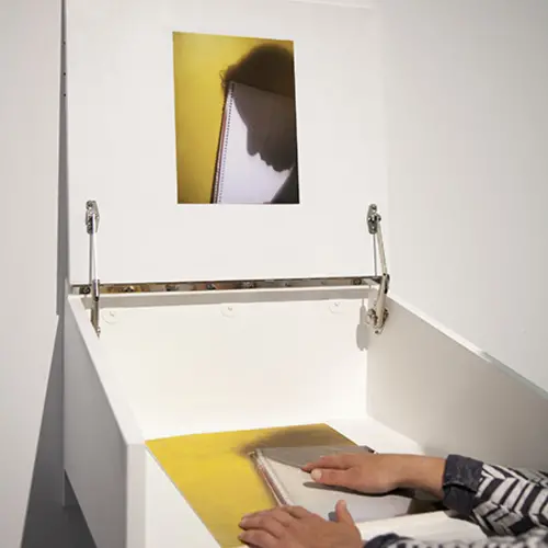 Hands feeling a tactile print with an image printed on it.