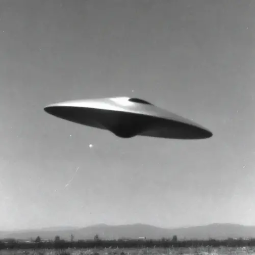 A UFO flying over a landscape