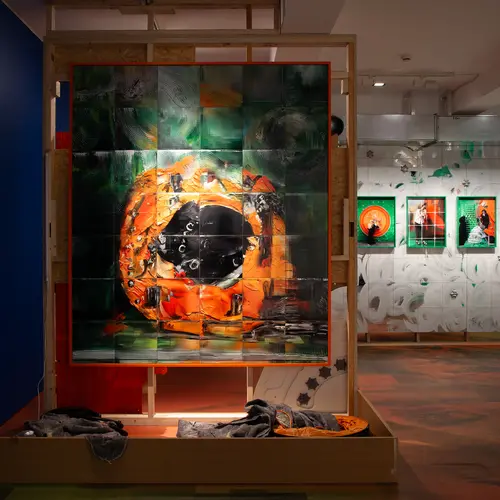 An install shot from the Felicity Hammond V3 Model Collapse exhibition. A large framed image of a collapsing generative image stands in front of three smaller framed iterations in the background.