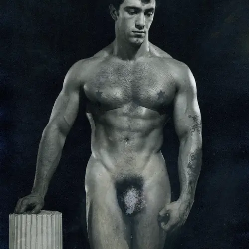 Image of a nude Spencer Churchill posing in a studio next to a plinth