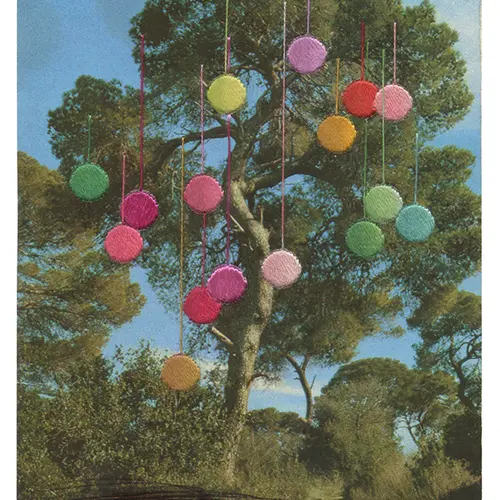 A colour print of a large green oak tree. Colour baubles hang from the branches which have been sewn into the image with coloured thread.