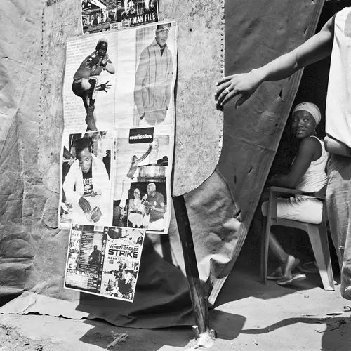 Woman sitting behind curtain