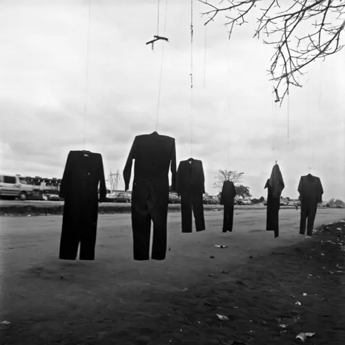 6 suits hanging suspended