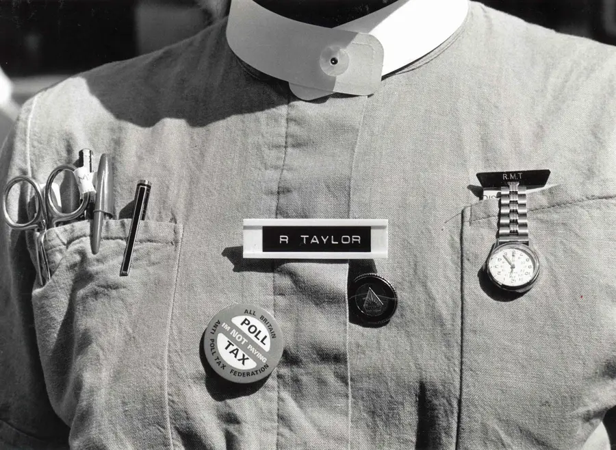 A nurses uniform including a Poll Tax badge