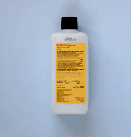 A bottle lying on a blue background.