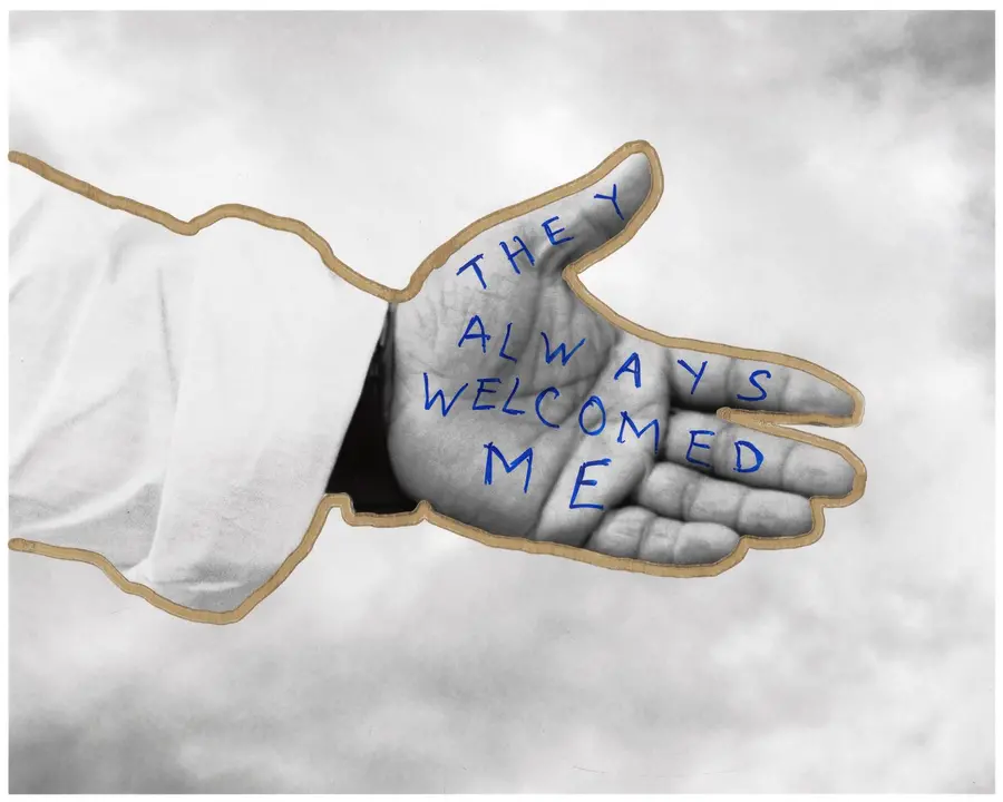 Black and white image of hand reaching out, with words 'They always welcomed me' drawn on the palm.