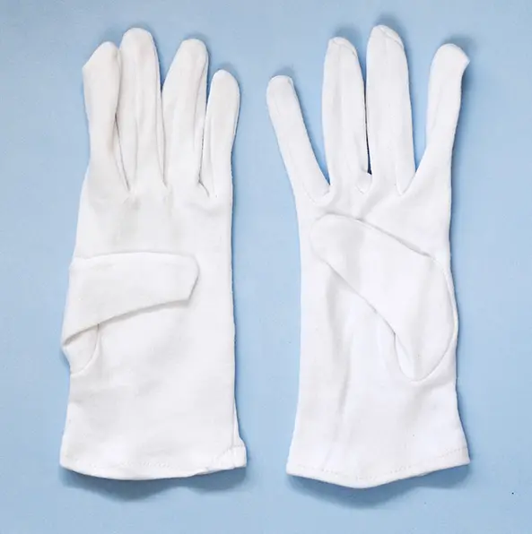White gloves laid out on a blue background.