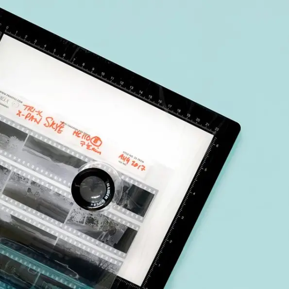 A loop on top of a sleeve of film on a blue background.